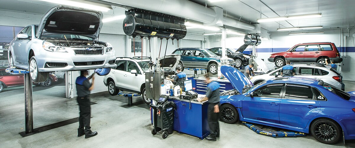 Skilled technicians performing maintenance activities in a Subaru service center